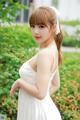 A woman in a white dress posing for a picture.