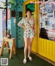 A woman standing in front of a yellow door.