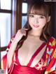 A woman in a red kimono posing for the camera.